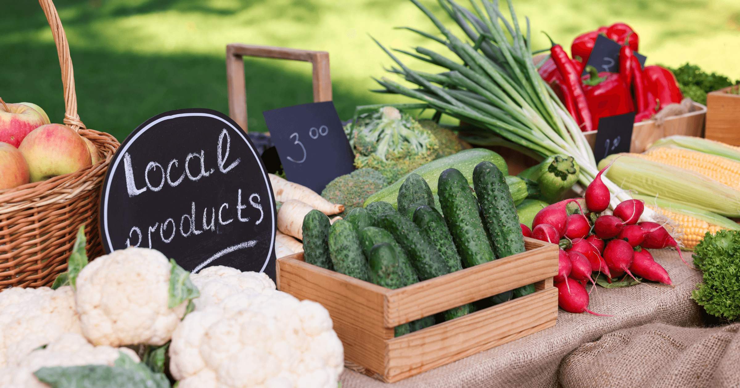 Local products at a farmers market — fresh vegetables in wooden crates